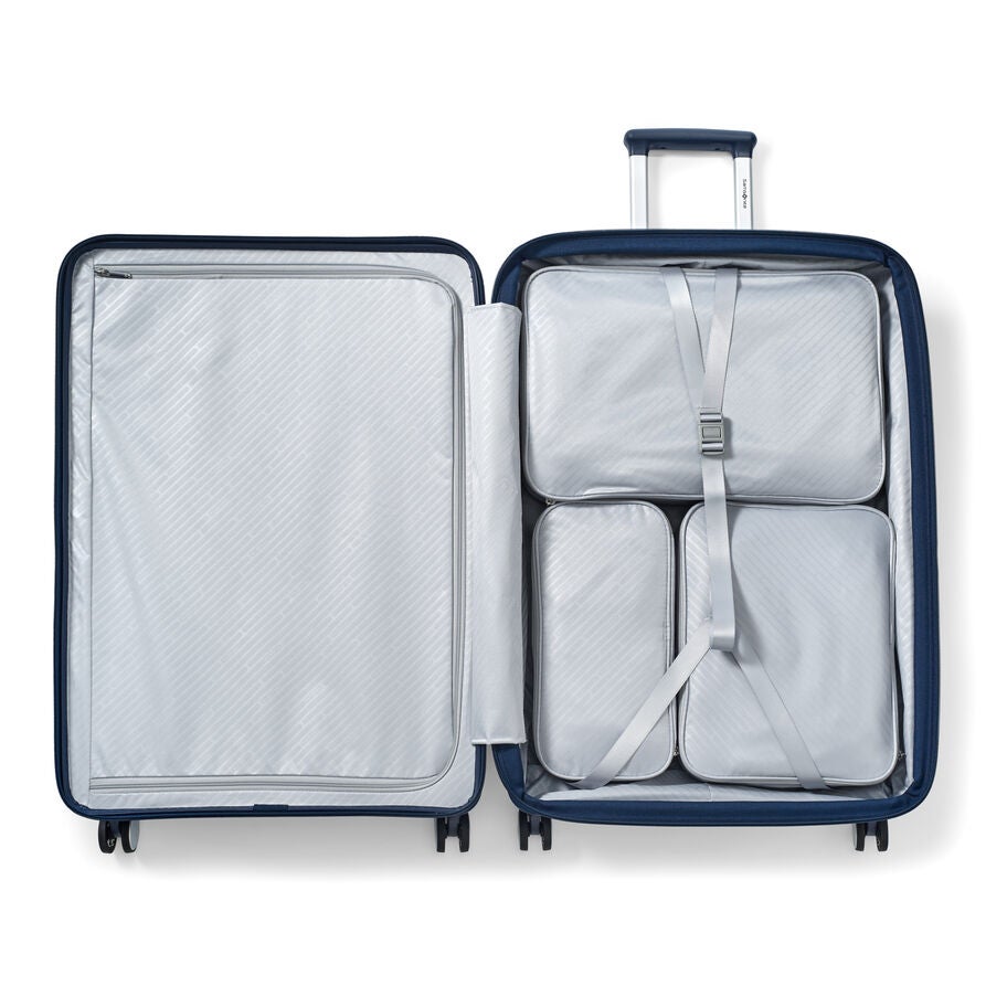 Open Paralux packing system inside navy suitcase with packing cubes