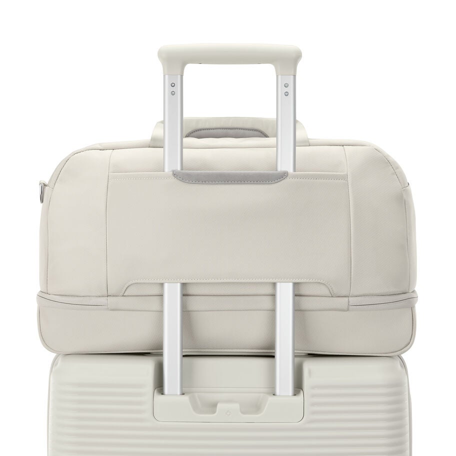 Back view of beige rolling weekender with extended handle