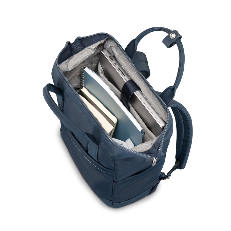 Open main compartment of blue Samsonite backpack filled with books and laptop