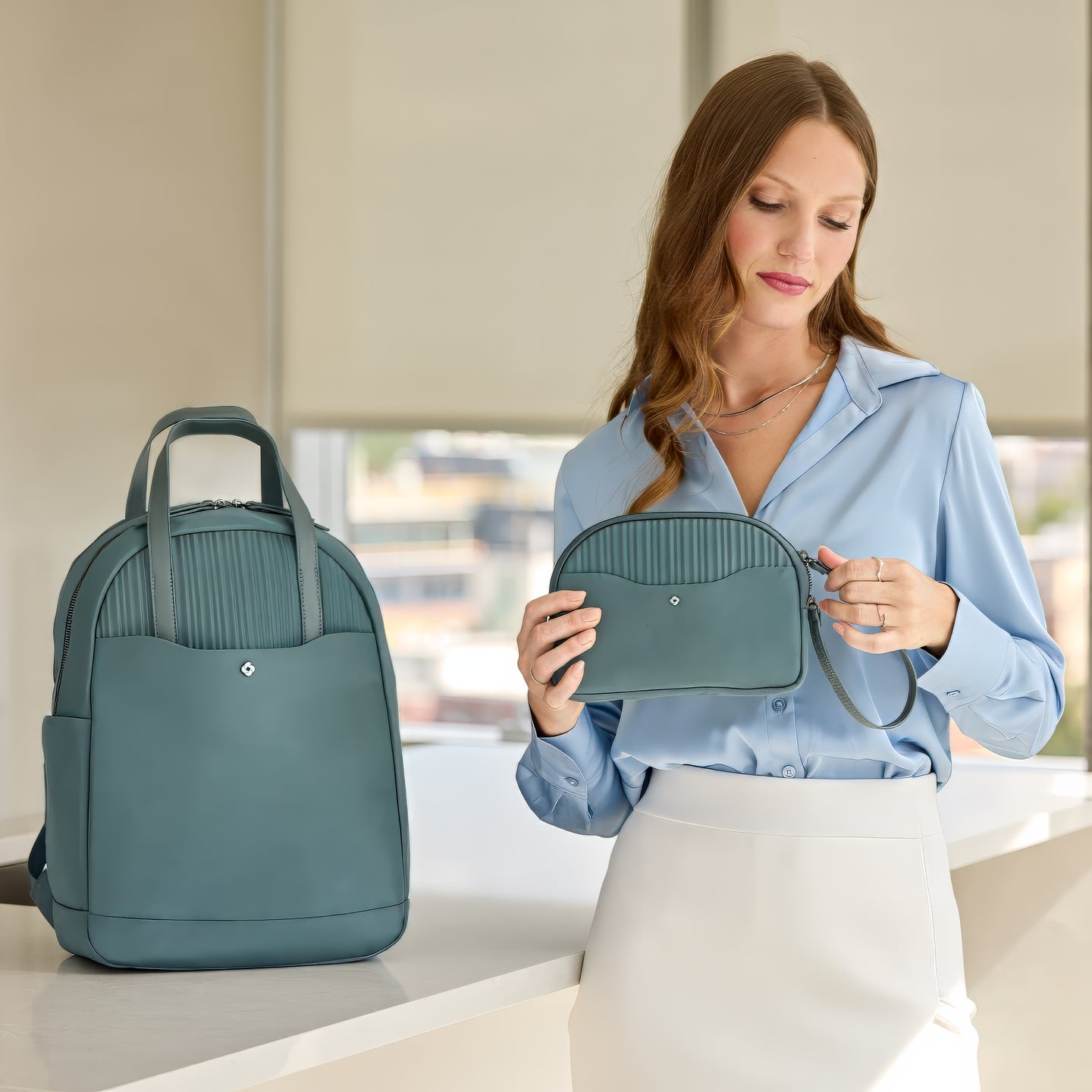 Detachable wristlet magnetically secured inside the main compartment. Sized to fit phone, wallet and keys.